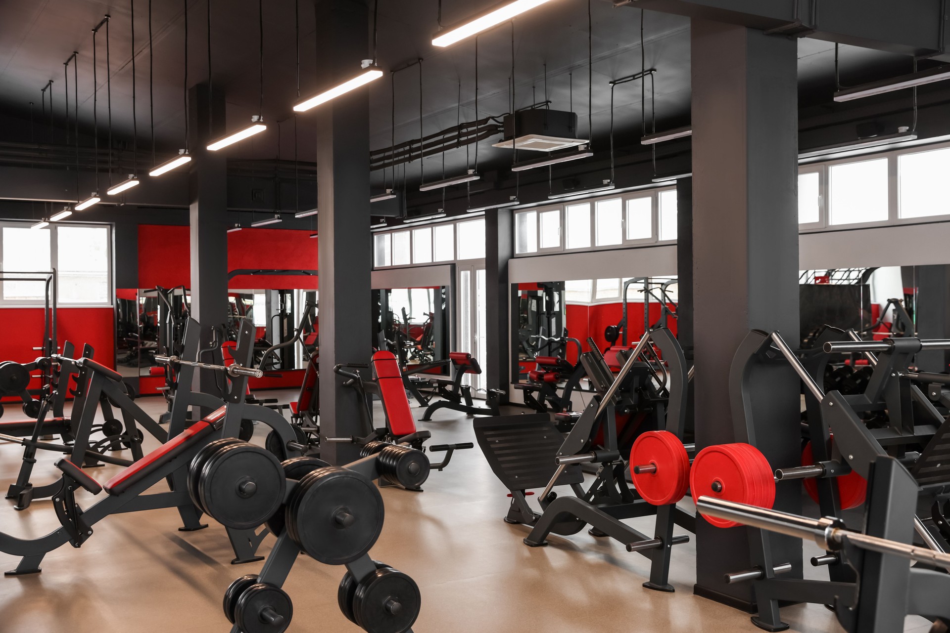 Spacious gym with professional equipment and mirrors